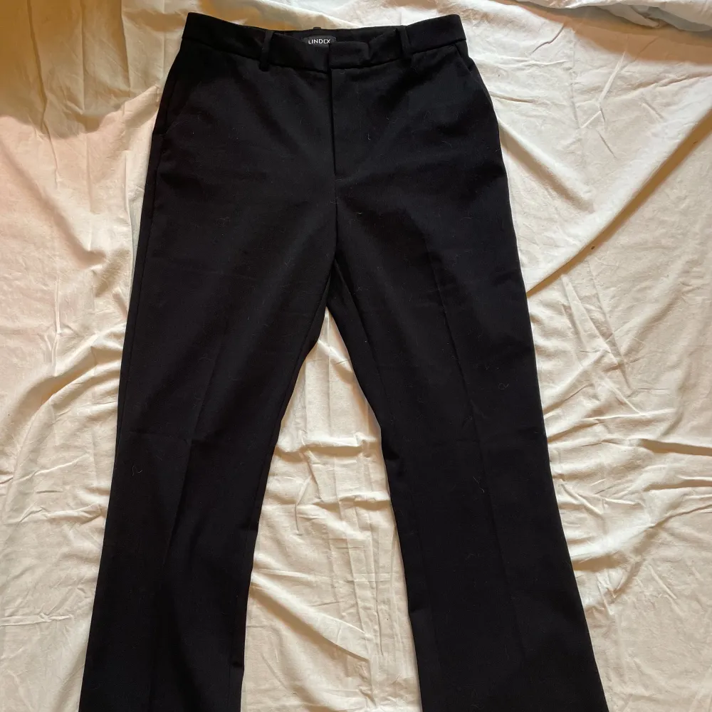 Svarta kostymbyxor med fickor, modellen ”Fiona” i fint skick. Knapp, blixtlås och plats till bälte. Sköna på sommaren.. Jeans & Byxor.