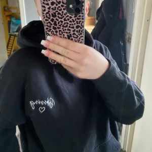 Svart luvtröja - Står tyvärr ingen storlek men skulle gissa på S/M ungefär, det står blessing vid brösten och även ett hjärta. 