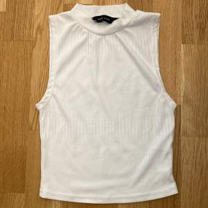 White sleeveless top that’s perfect for summer. The label is torn which you will be able to see in the second picture.