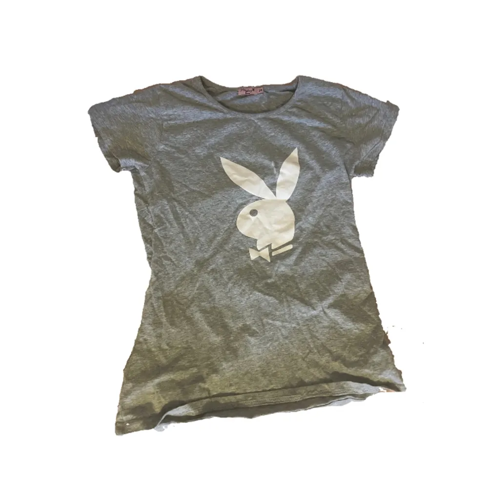 sleek gray Playboy top adorned with the iconic Playboy bunny print. Crafted in size M. T-shirts.