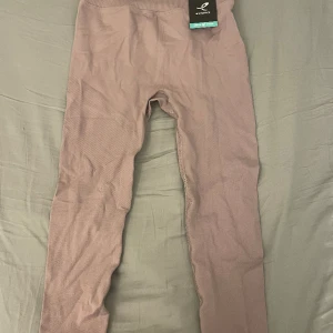 Tränings tights  - Ljuslila tränings tights. Har aldrig kommit till användning och har prislappen kvar. Är i L men passar även bra på mig som har M