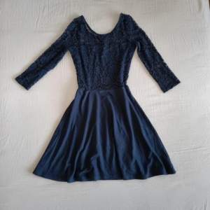 Mörkblå klänning med spets och trekvartsärm. Använd en gång 
