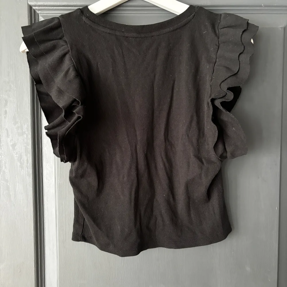 Denna tröja är från Zara och är i storlek L men är liten i storleken så snarare en storlek M. Den är använd men fortfarande i bra skick. Det är en top som är kort i längden och sitter åt . Toppar.
