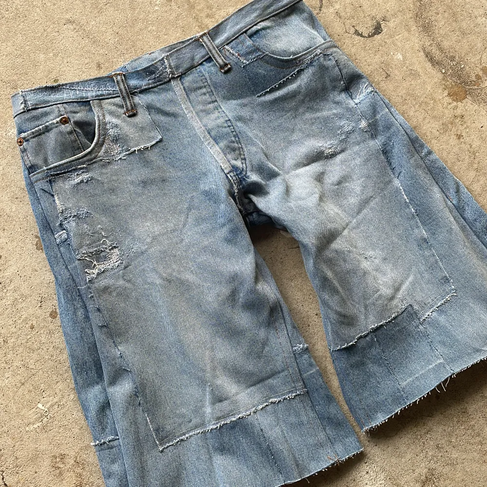 Crafted from vintage denim, this piece features multiple pairs of different jeans entirely reconstructed with a inner lining for comfort.. Shorts.