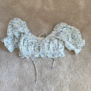 Vitt blommig topp - Vitt blommig topp från gina tricot i storlek 34