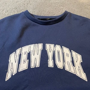 Blå sweater  - Markblå sweater med new york print 