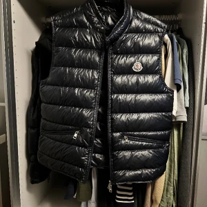 Moncler Gui   - Moncler Gui väst i Navy. Västen är storlek 3 Inga flaws 10/10 skick. ✅ Inget kvitto då jag fick den i present. 🎁 Äkthetsbevis kan skickas i form av bilder på västens detaljer. 📸  Köpt December 2022. Burits ca 10 gånger.  Köparen står för frakten. 📦 