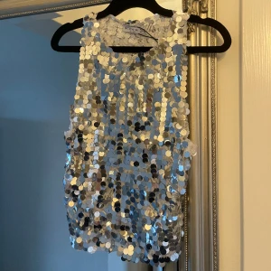 Festtopp  - Festtopp från stradivarius, använd en gång🤍 paljetterna släpper  Bild två defekt där paljetter släppt och sömmar gått upp lite 