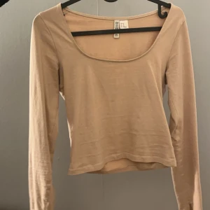 Fin urringad tröja - En jättefin beige tröja som är urringad och ” uppklippt” i ärmen så som på Gina tröjorna, en doup på Gina tröjorna