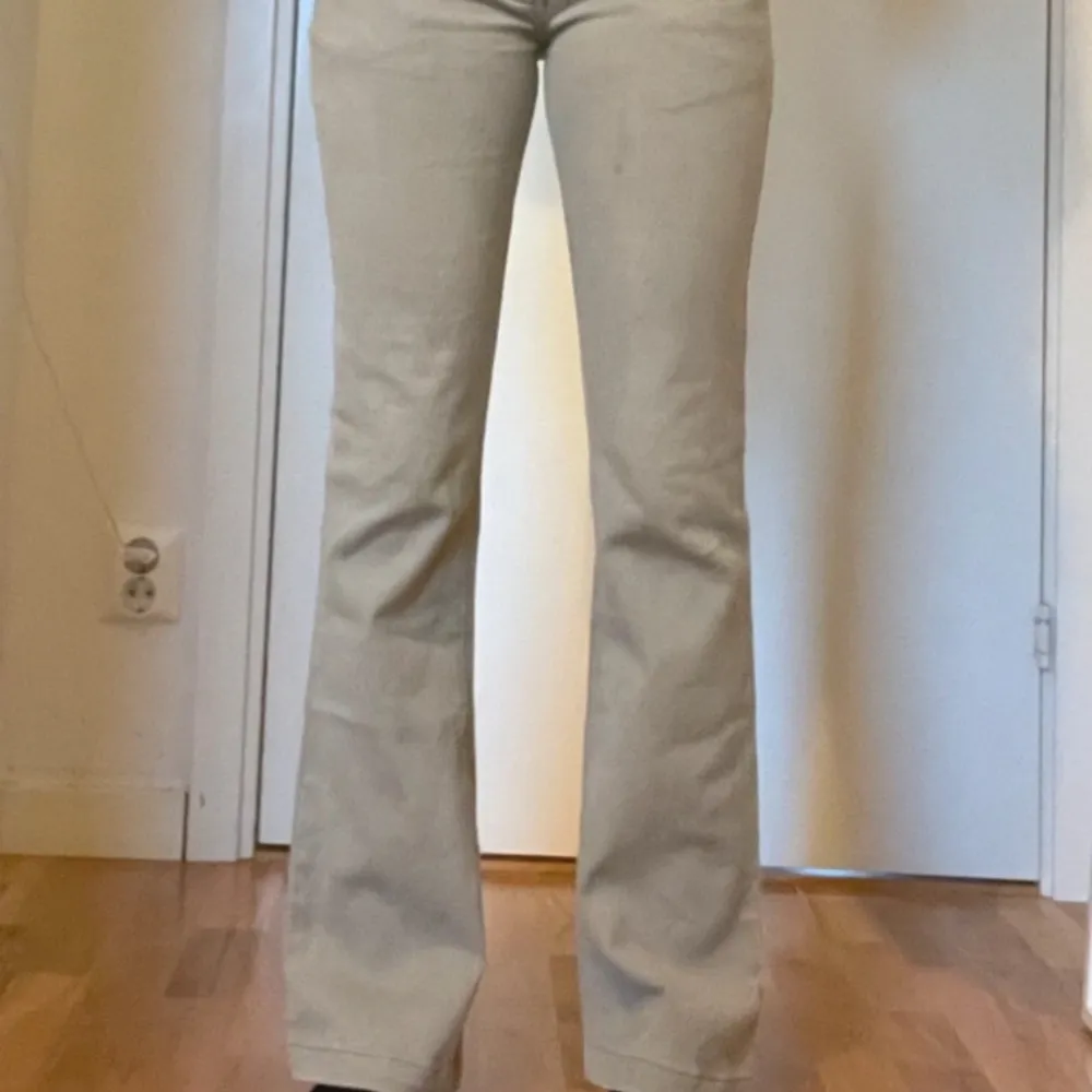 Beiga lågmidjade bootcut jeans med coola detaljer! Måtten är: Midjemått: 37cm Innerbenslängd: 76cm Längd tvärs över: 98cm Använd gärna köp nu!💘🔥😽. Jeans & Byxor.