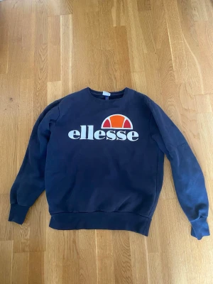Mörkblå sweatshirt från Ellesse - Säljer en fin mörkblåa tjocktröja. Tröjan är från märket Ellesse och har ett stort märke på bröstet. Färgen är marinblåa och den är i väldigt fint skick. Tröjan är i storlek M. Pris går såklart att diskuteras