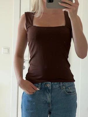 Brun topp - En brun topp med breda axelband och fyrkantig ringning i storlek XS från HM :)