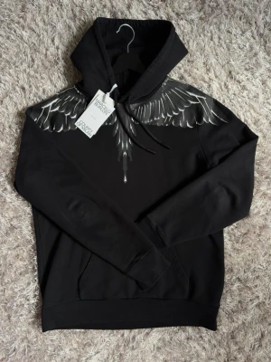 Marcelo Burlon hoodie - Marcelo Burlon Hoodie i storlek S. Svart/grå färg. Mycket fint skick (9/10) utan hål, fläckar eller andra defekter. Använd men väl omhändertagen