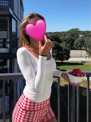 Vit långärmad topp från Gina Tricot - Säljer en vit långärmad topp från Gina Tricot med djup v-ringning. Toppen är tight i modellen och passar perfekt till både jeans och kjol. Tillverkad i mjukt material som känns skönt mot huden. Enkel och stilren design som är lätt att matcha.