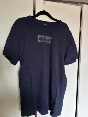 Mörkblå t-shirt från Bula  - Snygg mörkblå t-shirt från Bula i storlek XL. T-shirten har ett tryck med Bula-loggan på bröstet och är tillverkad i mjuk bomull. 