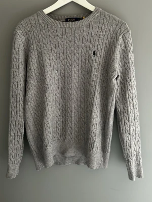 Kabelstickad Ralph lauren tröja - Fin grå kabelstickad tröja från Ralph lauren. Som ny använd endast några gånger. Storlek S. 
