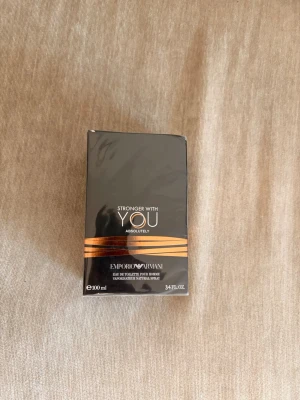 Emporio Armani Stronger With You - Emporio Armani Stronger With You Absolutely är en parfym för honom i en elegant svart förpackning med guldiga detaljer. Flaskan rymmer 100 ml och har en modern, stilren design som känns lyxig och exklusiv. Perfekt för dig som gillar maskulina och intensiva dofter.