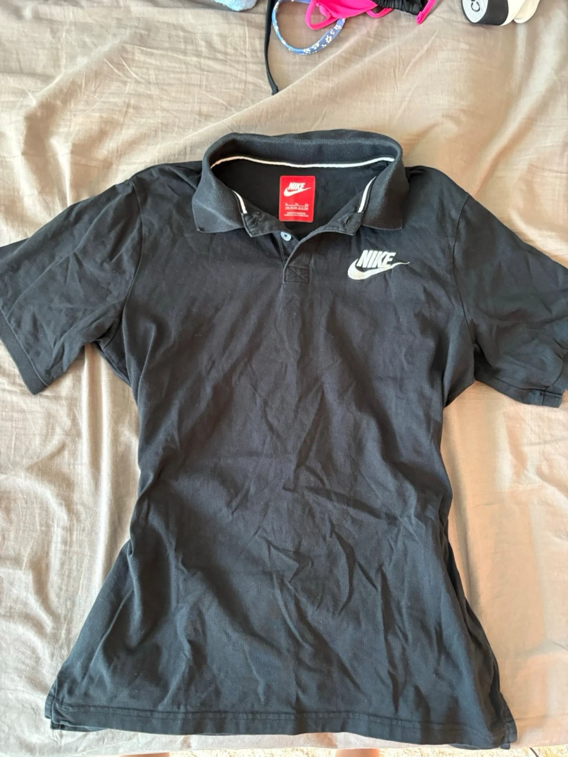 Svart pikétröja från Nike