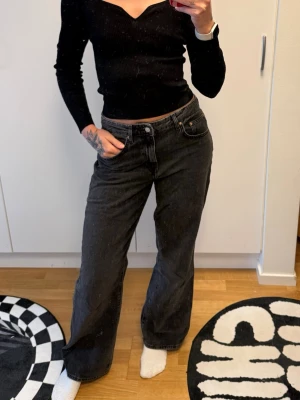 Svarta vida jeans från Gina tricot - Säljer ett par svarta jeans från gina tricot Jeans i storlek 40. Jeansen har en rak och vid passform med hög midja och klassiska fem fickor. Materialet är mjukt denim och färgen är tvättad svart, perfekt för en avslappnad och trendig look.