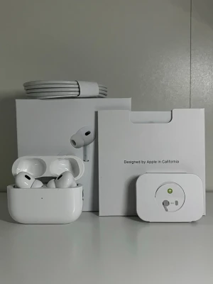 AirPods Pro 2 - komplett -  Säljer ett par original AirPods Pro (2:a generationen) i gott skick.  Levereras komplett med originalförpackning, USB-C-kabel och extra öronpluggar.  Serienumret stämmer med boxen, fodralets insida, AirPods:en och iPhone-inställningarna. Translate to English 