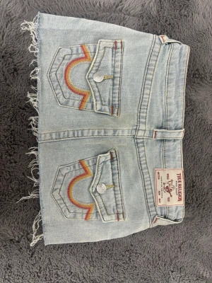 Ljusblå jeanskjol True Religion - Säljer en jätte fin ljusblå true religion kjol, sitter jättebra och är lågmidjad, inprincip oanvänd och i nytt skick. Säljer eftersom jag råkade beställa en för liten storlek. 💕💕💕 