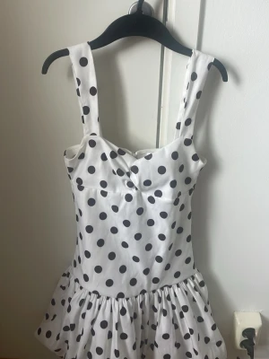Vit prickig klänning från Zara - Populär Snygg vit klänning från Zara med svarta prickar och breda axelband. Jag säljer för att den är för liten🤍🖤