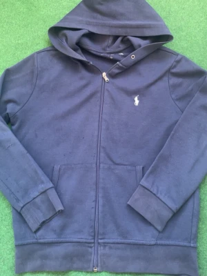 Mörkblå hoodie från Polo Ralph Lauren - Mörkblå hoodie med dragkedja från Polo Ralph Lauren.  STORLEK S MEN PASSAR SOM M