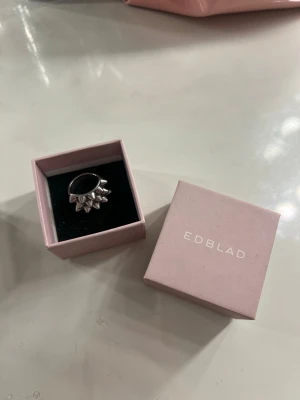 Silver ring från Edblad - Säljer en silver ring från Edblad. Ringen har taggar på sig och kommer i original ask. Storleken är 17.50, så typ storlek S. Nästan helt oanvänd och är i bra skick. Säljer ringen för att jag numera använder guldsmycken.