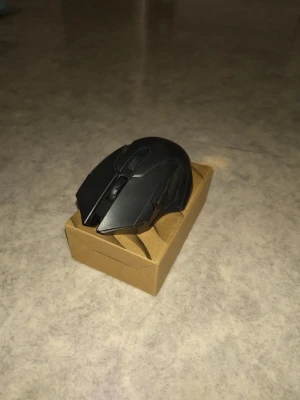 Svart trådlös datormus - Snygg svart trådlös datormus med modern design och DPI-knapp på ovansidan. Musen har en matt finish och är tillverkad i plast. Perfekt för gaming eller studier, och levereras i en enkel kartong.