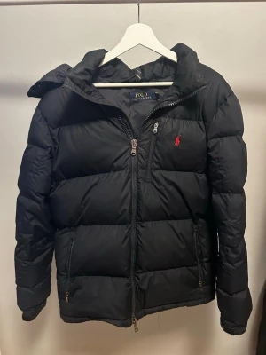 Svart dunjacka från Polo Ralph Lauren - Snygg svart dunjacka från Polo Ralph Lauren i storlek L men passar också M.