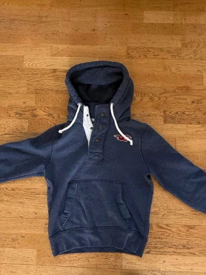 Hollister vintage  -  Mörkblå Hollister hoodie i storlek S (passar även XS för en lite oversize fit).  Äldre modell/vintage Hollister som inte säljs längre – svår att få tag på nu. Riktigt skön kvalitet och tjockare material än många nya hoodies. ❗️Bra i storleken  ❗️Kommer ifrån djur och rök fritt hem   Säljer då den inte kommer till användning. Skriv vid intresse!