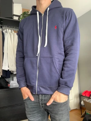 Ralph lauren zip hoodie  - Säljer denna riktigt snygga zip hoodien från Ralph lauren. Den är använt ett par gånger så skicket är fof mycket fint. Storleken är M men passar även S. Skriv vid fler frågor eller bilder.