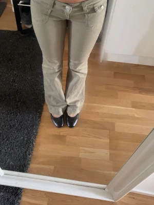 Nelly Light Green Low Waist Flared Pants - Super cute light green flared pants from Nelly Low waist fit with a flattering silhouette and slight stretch. Perfect for everyday wear or dressing up! • Size: 34 • Brand: Nelly • Color: Light green / khaki • Condition: used one time and selling because it’s not my style  • Fit: Low waist, flared legs Feel free to message me if you have any questions