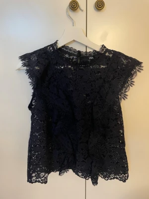 Mörkblå spetsblus från Zara - Snygg mörkblå blus från Zara i genombruten spets med blommigt mönster. 