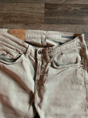Dondup jeans  -   Snygga ljusgrå Dondup-jeans i storlek 31, slim fit-modell. Perfekt för en stilren och bekväm look.