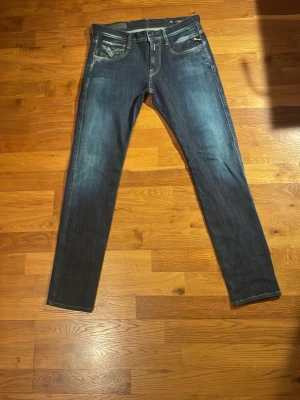 Replay anbass - Säljer ett par mörkblå slim fit jeans från Replay med en urtvättad still. Dem är i slim fit anbass modellen med W29 (38 cm) och L30 (95 cm) priset ej hugget