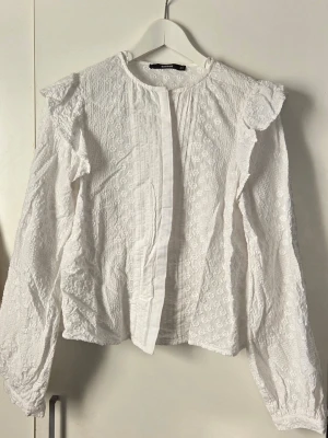 Vit blus från Bikbok  - Vit broderad långärmad blus med knappar. Använd vid ett tillfälle.
