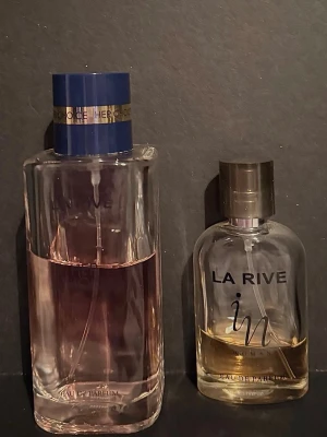 Två parfymer från La Rive - La Rive ”Her choice” som ska påminna om ”My way” och La Rive ”in” som ska påminna om ”Si”. Ca 70% kvar av her choice 100ml. Ca 30% kvar av in 30ml. Kommer ej till användning men har stått mörkt och svalt förvarat