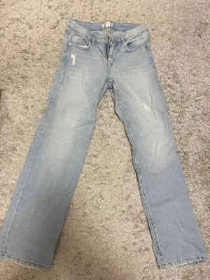 Måste ses! Supersnygga Gina-jeans – stl 152 - Säljer ett par superfina ljusblå jeans från Gina Tricot i storlek 152 (barnavdelning). Trendig rak modell med snygg ljus tvätt och diskreta slitna detaljer som ger en cool, modern look. Perfekta till både vardag och finare tillfällen – enkla att matcha med allt 🤍