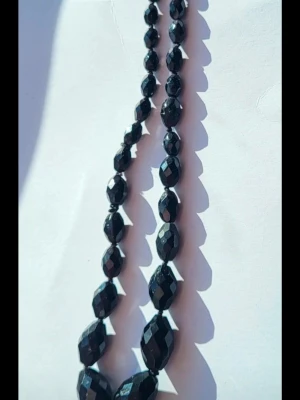 Antique necklace  - Glass mulifacted cut black necklace with metal clasp from the 1920s or 1930s. Reflects and sparkles. Some scuffs/ signs of wear, but that is to be expected with it's age.  Bundle discounts: two items 5% off (automatic) three items 10% off, five items 20% off. Message me before purchasing 3+ items for discount.