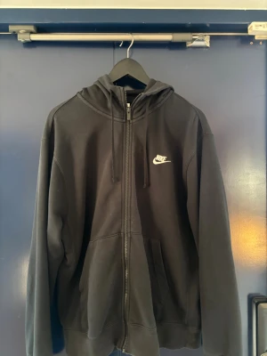 Svart zip hoodie från Nike - Svart kofta med luva från Nike. Sitter som en klassisk M eller lite större i storlek. Sitter bra på mig som är 180cm och runt 86kg. 