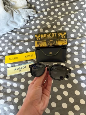 Moscot lemtosh solglasögon  - Säljer ett par riktigt snygga och clean solglasögon från moscot i modellen lemtosh, dem ar svarta med gråa linser och alla tillbehör på bilden medföljer, glasögonen är helt nya och polariserade vilket syns på sista bilden. Dessa är nog dem snyggaste på marknaden just nu och kvalitén är riktigt schysst. Frågor? Kontakta mig. Allt gott, mvh Noah