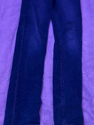 Mörkblå raka jeans från Levi's - Snygga mörkblå jeans från Levi's med klassisk rak passform och femficksdesign. Jeansen har en diskret tvätt och är tillverkade i slitstark denim. Perfekta för dig som gillar en tidlös och enkel stil.