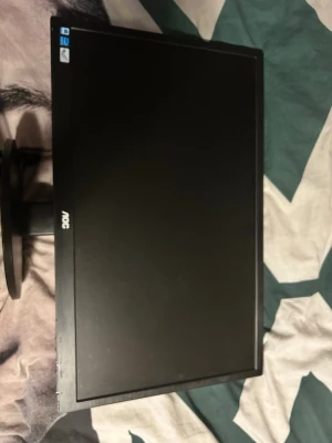 svart datorskärmen  - Säljer en svart datorskärm från AOC med rund fot och tunn ram. Skärmen har en stilren design och är tillverkad i plast. Perfekt för dig som vill ha extra skärmyta till datorn eller plugget. Finns inga kablar till det