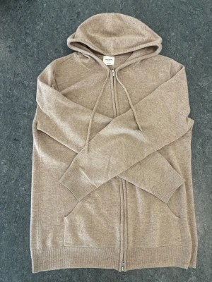 John Henric - Beige John Henric hoodie cashmere. Size M. Liten defekt vid armen. Pris kan diskuteras. Inga returer