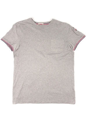 Moncler Tricolor Pocket T-Shirt - Information: Moncler Tricolor Grey T-Shirt, Left side chest pocket, 100% cotton, Embroidered logo on left side sleeve, Tricolor line around inside neck and at the end of sleeves, Size M  Condition: The T-Shirt has been gently used and is in very good condition. Pit to Pit: 52.5 cm / 20.7 Inches Chest: 105 cm / 41.3 Inches Length: 71 cm / 28 Inches