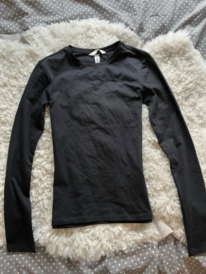 Långärmad svart tröja - Långärmad tröja i bomull från H&M i storlek xs, passar även xxs. Helt ny och oanvänd. Jag skickar snabbt, som snabbast med instabox💓