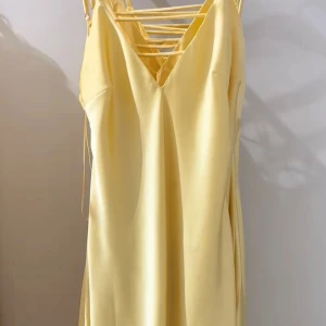 Gul sidenklänning med öppen rygg - Säljer denna superfina gula satinklänningen från Zara, endast provad därav nyskick med prislapp kvar! 🥰