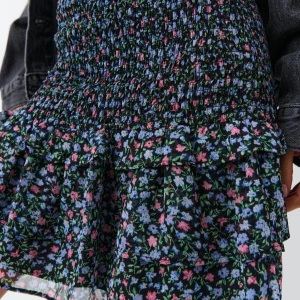 Blommig boho smock skirt - Söt blommig kortkjol med volangdetaljer. Kjolen har en elastisk midja och ett färgglatt mönster i blått, rosa och grönt på en svart bakgrund. Perfekt för en somrig look! Material: 97% polyester,3% Elastan. Tvättråd: skontvätt 40C. Original pris 359.95 SEK. Men jag säljer för 200 Kr. Pris går att diskutera