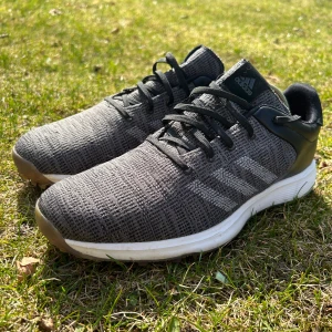Grå Adidas golfskor - Säljer ett par grå Adidas golfskor med svart snörning och vit sula. Skorna har aldrig använts så är det helt nyskick. Storlek är 42 3 / 2 men sitter som 43